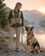 Woman and German Shepherd by a lake in matching camo gear